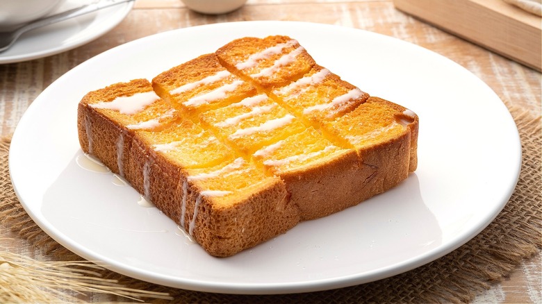 Piece of thick toasted white bread with icing