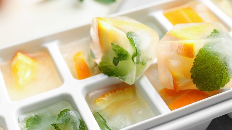 Ice cubes filled with orange and mint