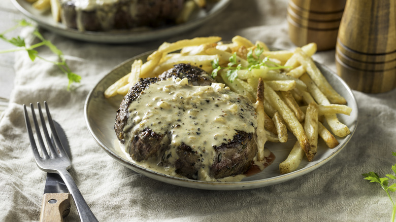 Steak au poivre on a rustic tablecloth