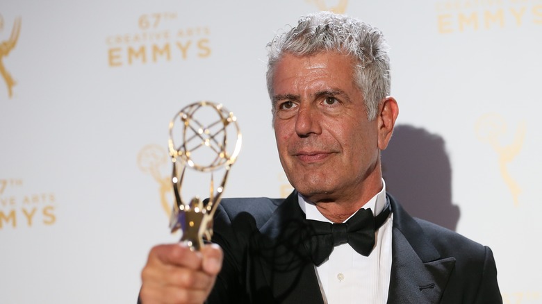 Bourdain holding his Emmy