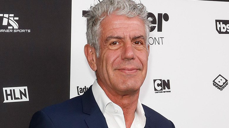 Anthony Bourdain wearing suit and white shirt