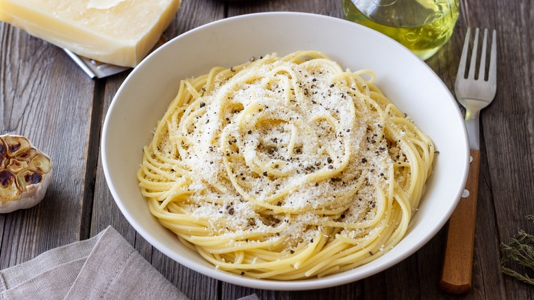 Bowl of cacio e pepe pasta with grated cheese