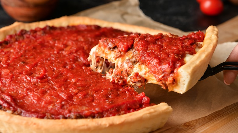 Slice being taken from a Chicago-style deep dish pizza