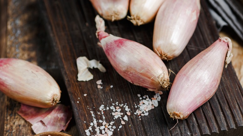 Shallots on a cutting board with salt