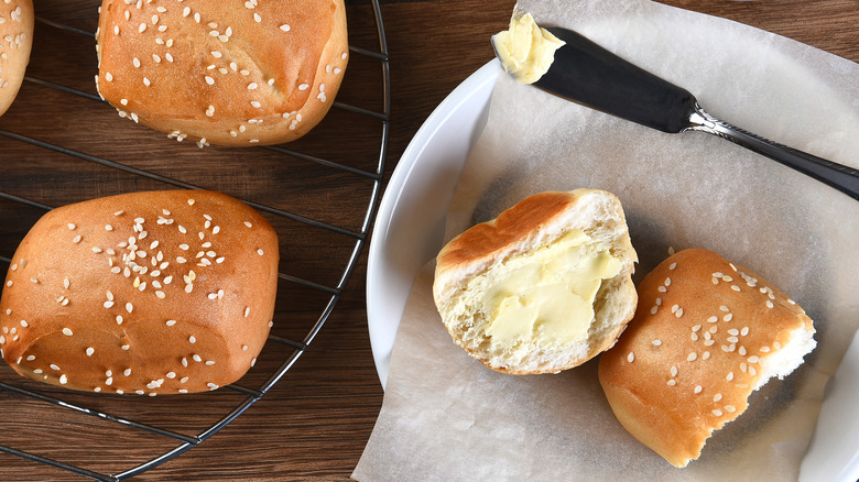 buttered dinner roll with knife
