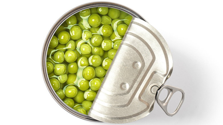 Green peas canned isolated on white background.,