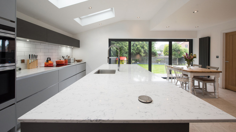 A modern kitchen with a large, white quartz island