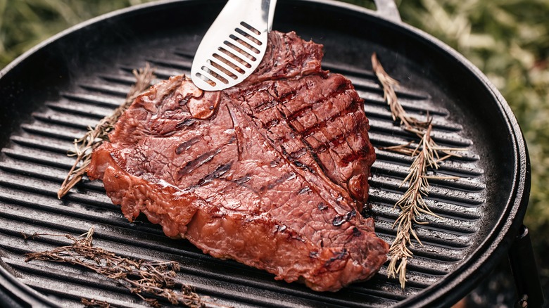 T-bone or porterhouse steak being cooked