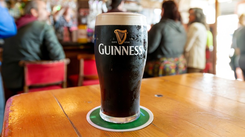 Full pint of Guinness beer on a table in a pub