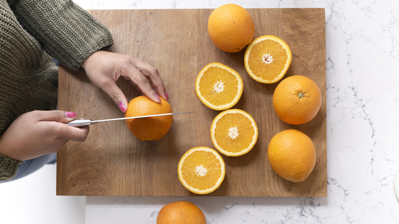 Person slicing oranges