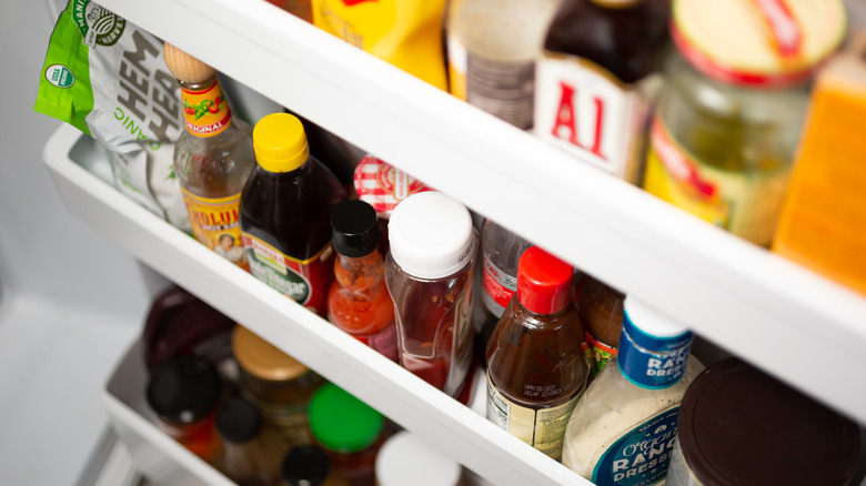 fridge door full of condiments