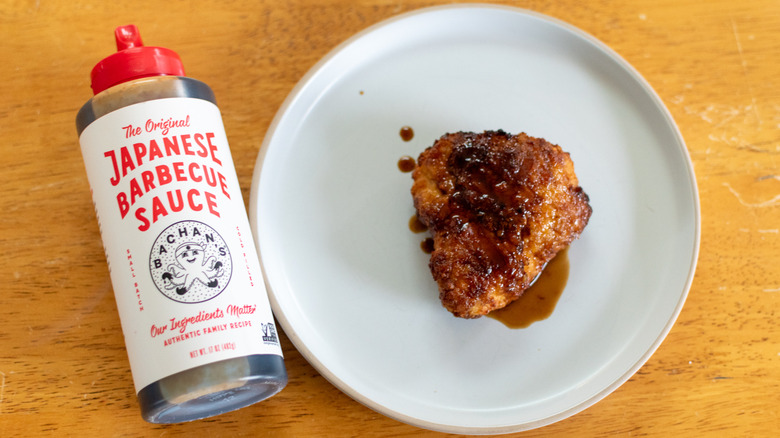 Crispy chicken on white plate with Bachan's Japanese barbecue sauce