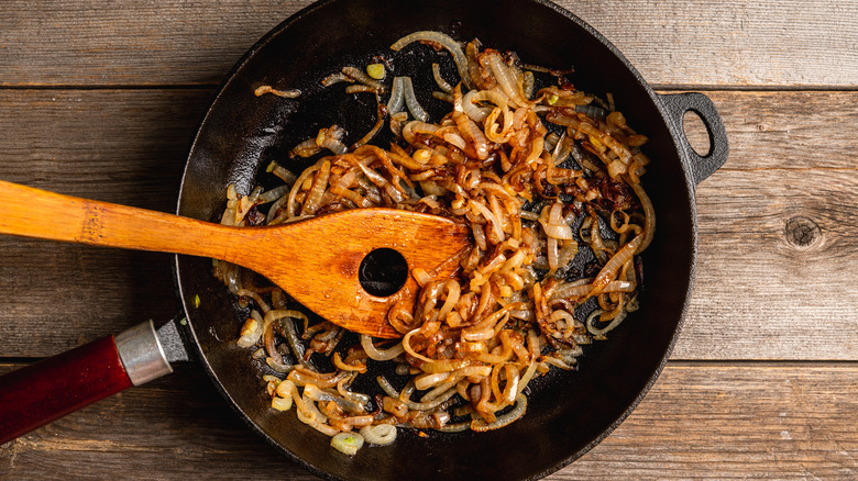 Caramelized onions cooking with spices in skillet