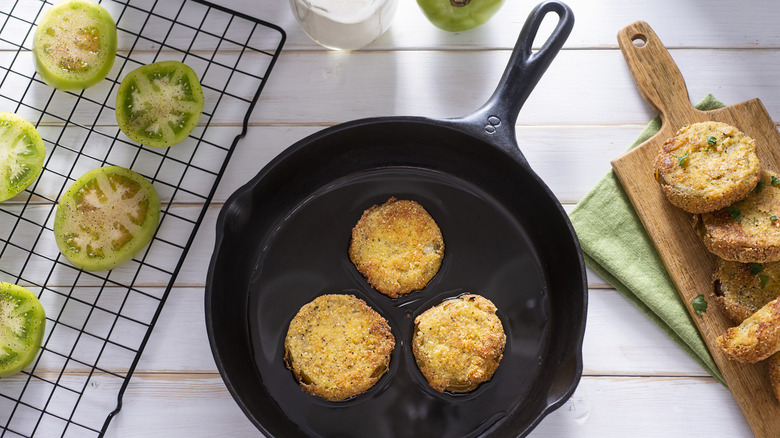 Cooking fried green tomatoes in cast-iron pan