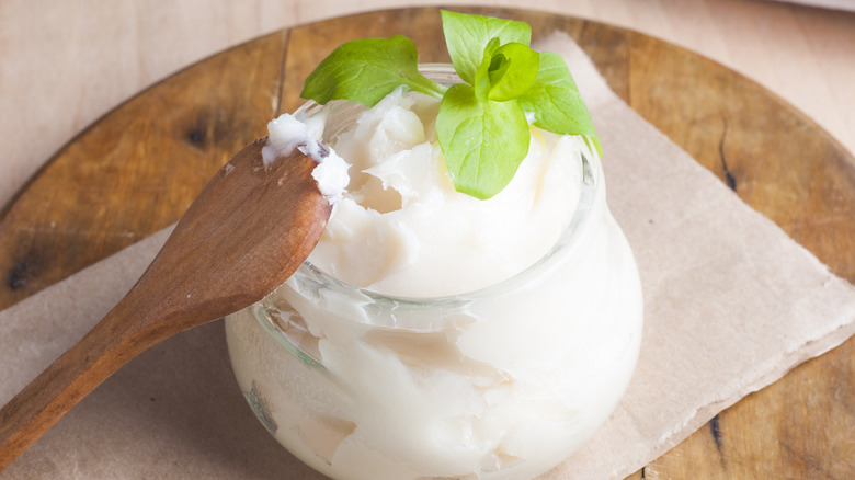 jar of pork fat with wooden spoon