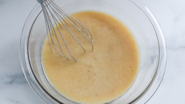 whisking wet ingredients donut dough