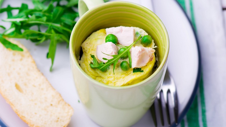 Egg souffle with chicken and peas in mug