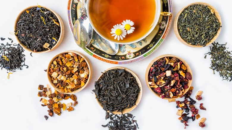 Variety of different teas with cup of brewed tea in cup