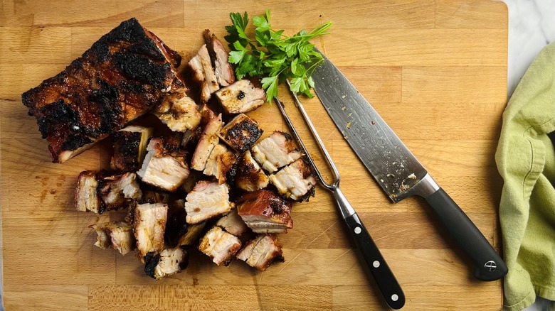 chopped pork belly on board