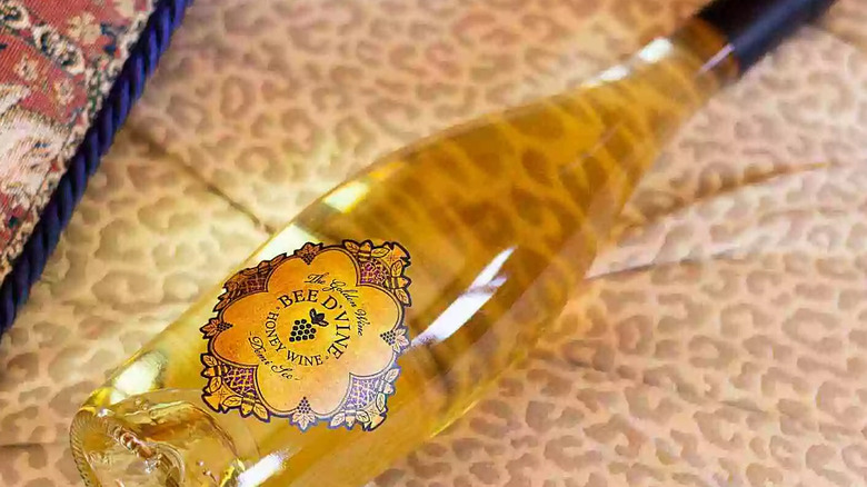Bottle of honey wine by Bee D'Vine on leopard print fabric