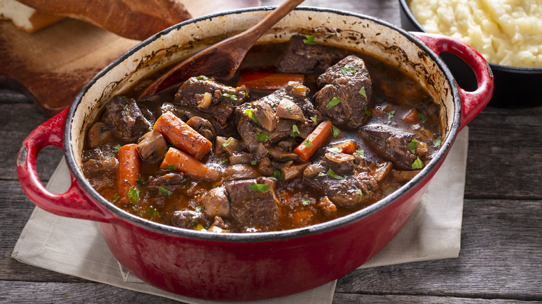 A Dutch oven filled with boeuf bourguignon