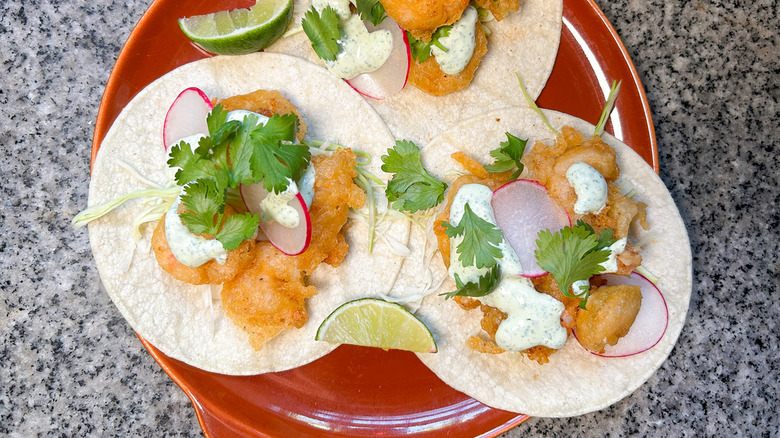 shrimp tacos on orange plate