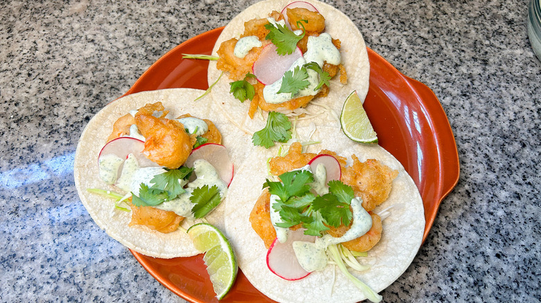 shrimp tacos on orange plate
