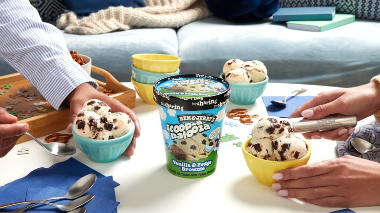 Ben & Jerry's ice cream being scooped into two bowls by two people