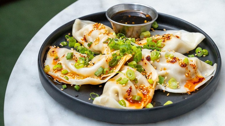 Plate of vegan dumplings with dipping sauce from Beyond Sushi