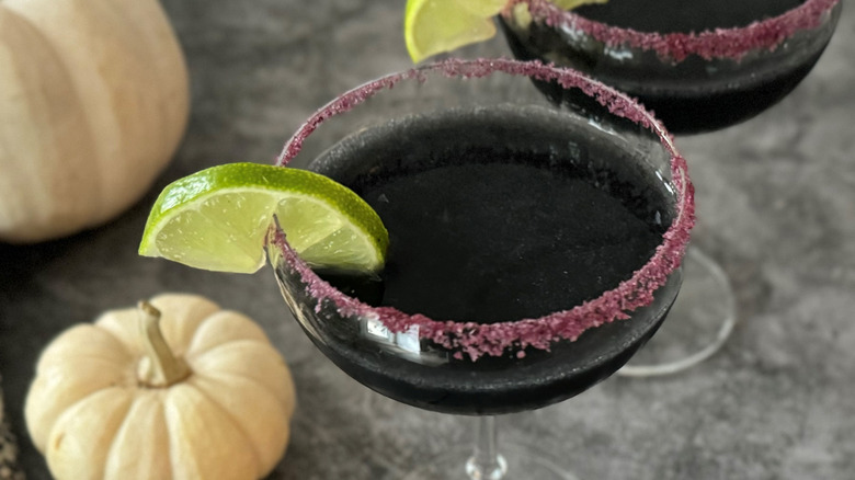 black cocktails with lime wedge