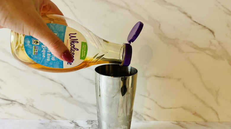 agave syrup pouring into shaker