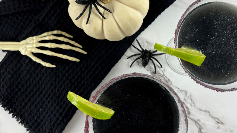 black cocktails with Halloween decor