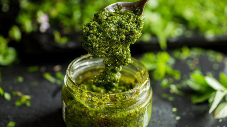 fresh pesto spooned into a jar