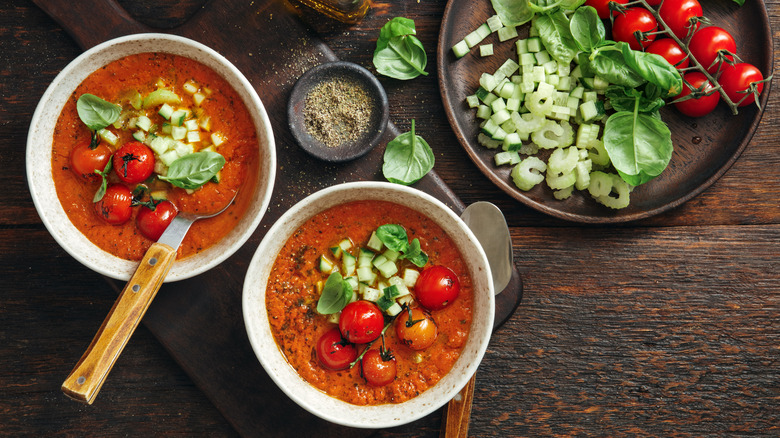 Bowls of gazpacho soup with fresh vegetables