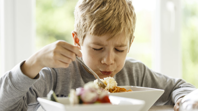 Kid blowing on his food