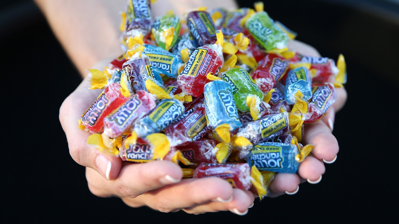 hands holding jolly ranchers