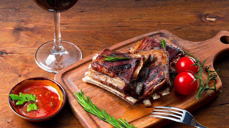Grilled meat with barbecue sauce and glass of red wine