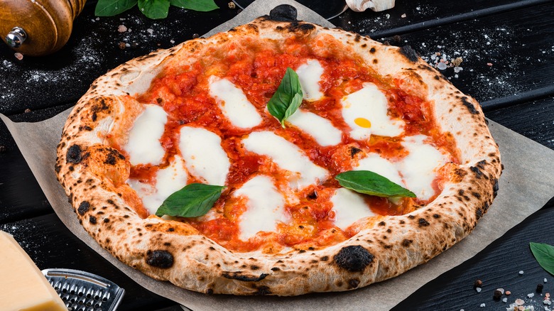 Neapolitan style pizza with mozz, sauce, basil