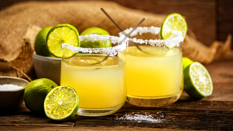 Traditional margaritas with a classic salt rim and lime garnish