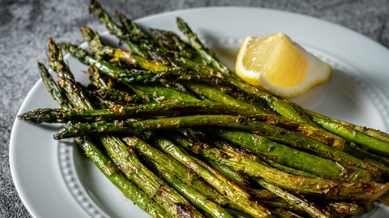 Cooked asparagus on a white plate