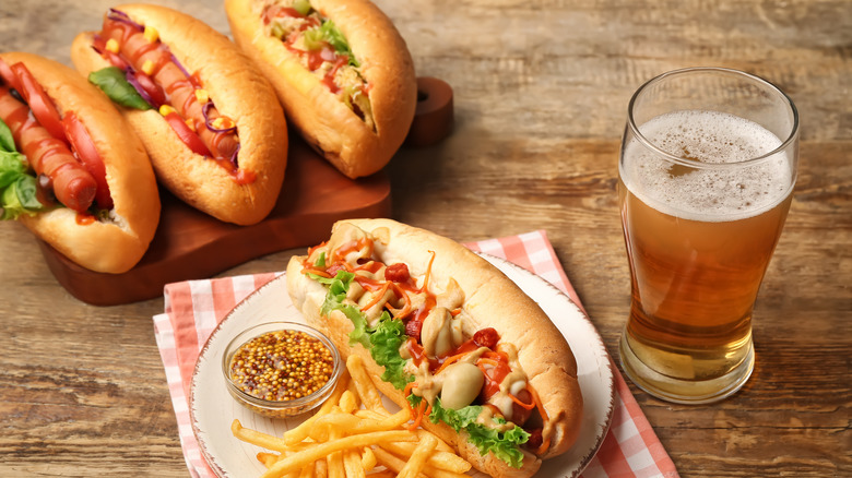 hot dogs served with mustard and beer