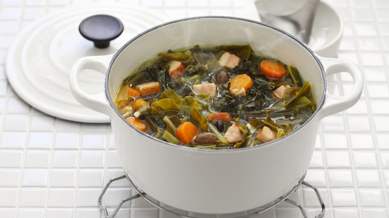 Dutch oven with collards, meat, carrots