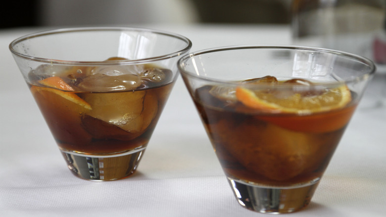 Two Boulevardier cocktails with orange