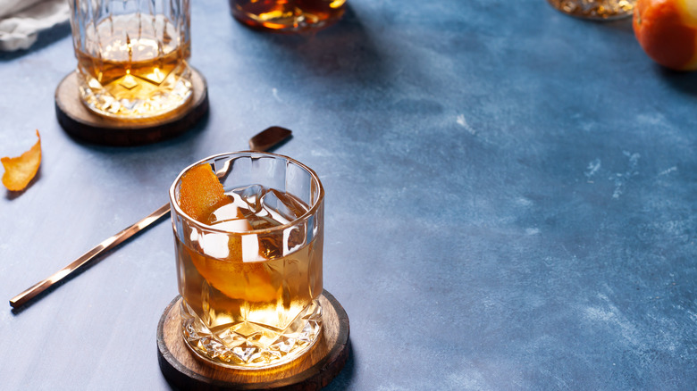 Clear glasses of bourbon over ice