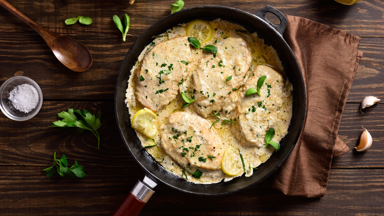 Cooked chicken breasts with a garlic herb cheese sauce