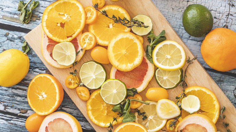 Lemon, kumquats, orange, grapefruit, and lime on cutting board