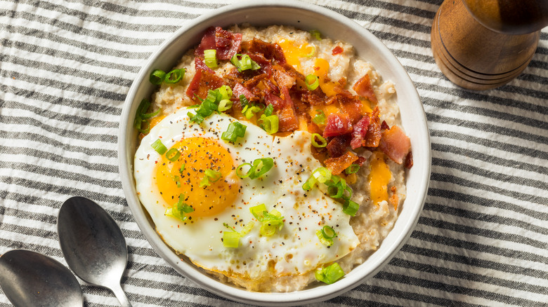 Breakfast oatmeal with egg, bacon, cheese, scallion