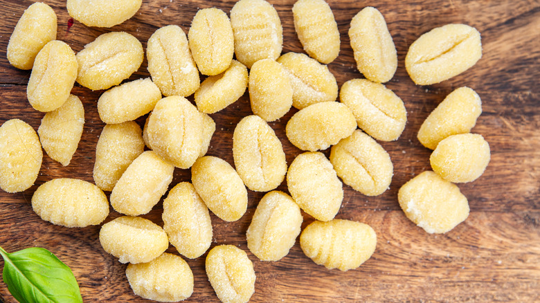 Raw potato gnocchi on wood cutting board