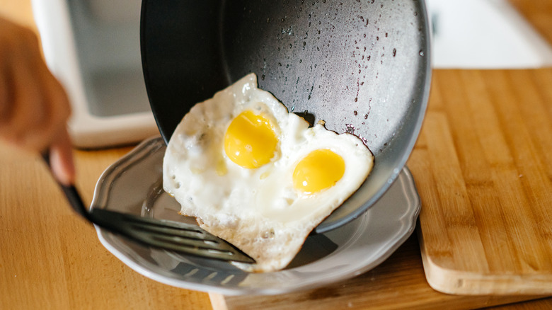 Fried eggs from pan with olive oil