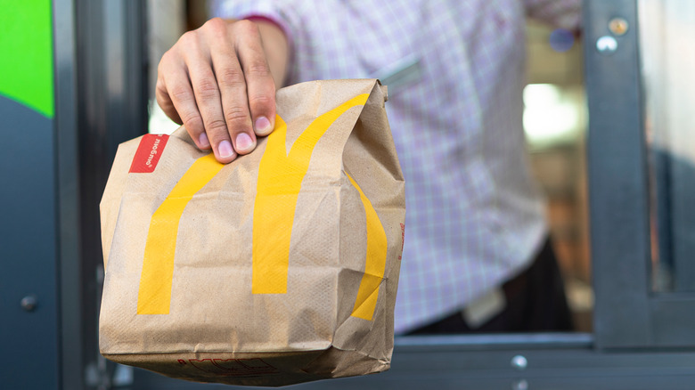 McDonald's bag being handed through a drive thru